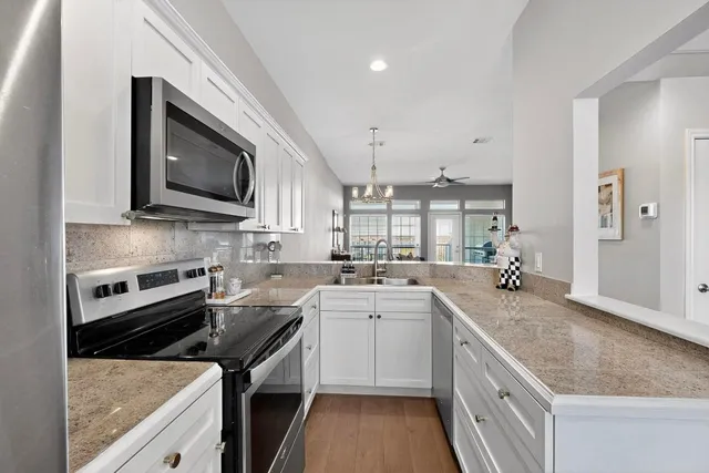 a kitchen with a sink stove and microwave