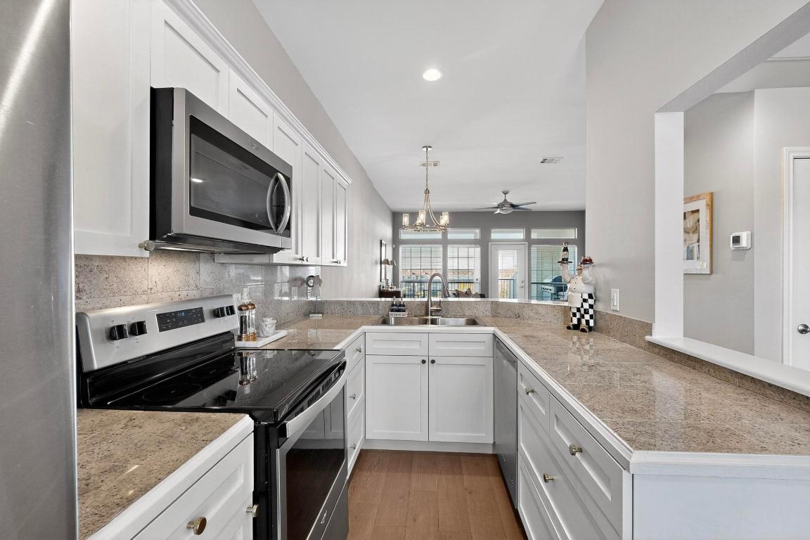 2918 Ranch Road 620 North, Unit T250 Austin, TX 78734 - Photo 8 of 22 a kitchen with a sink stove and microwave