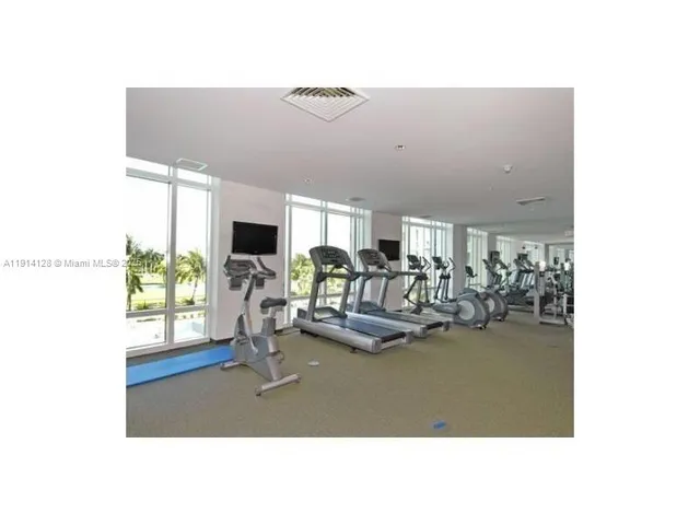 a view of a living room with furniture and a floor to ceiling window