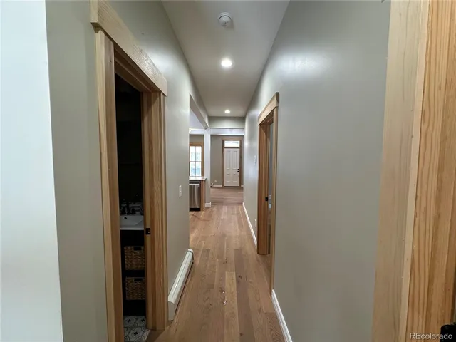 a view of a hallway with wooden floor