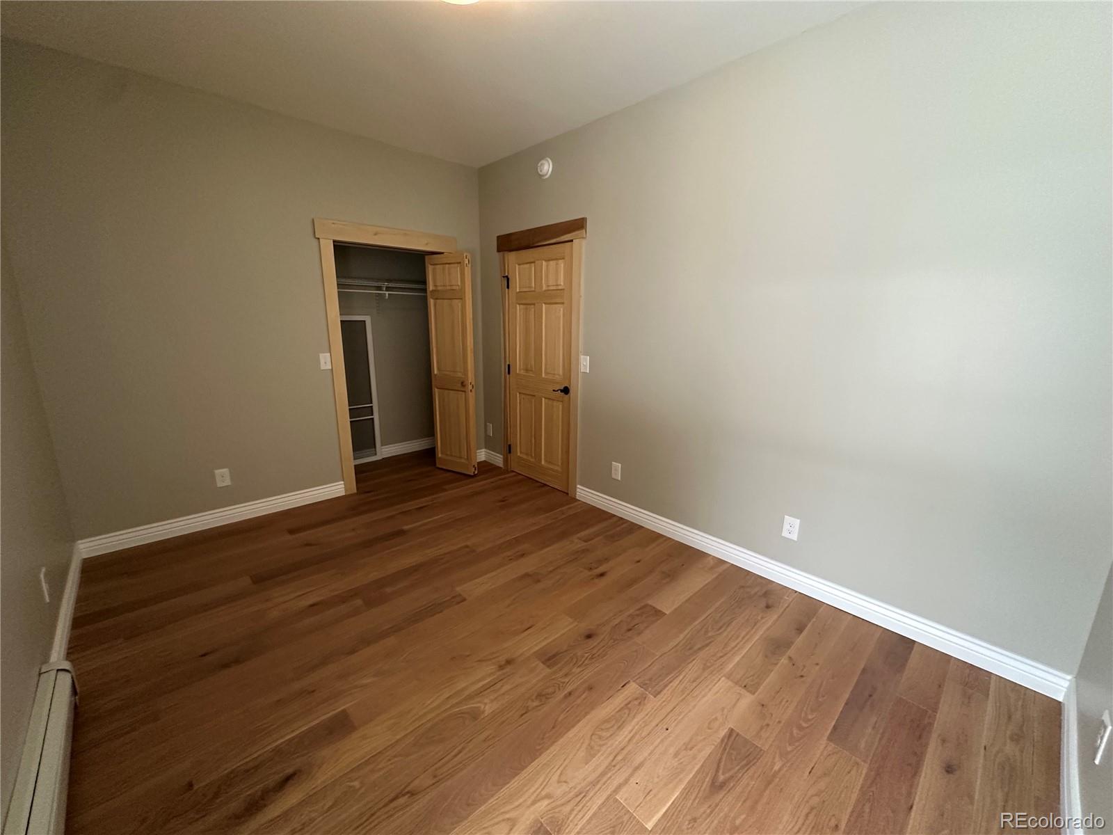 902 Rose Street Georgetown, CO 80444 - Photo 13 of 23 a view of an empty room with wooden floor and closet