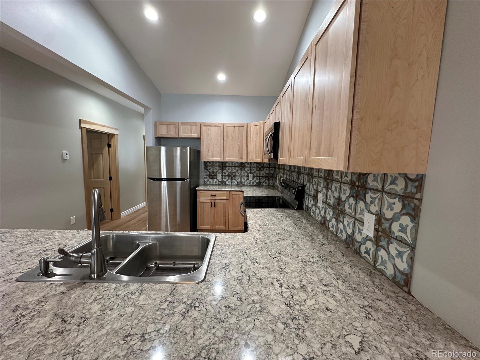 902 Rose Street Georgetown, CO 80444 - Photo 7 of 23 a kitchen with stainless steel appliances granite countertop a sink refrigerator and cabinets