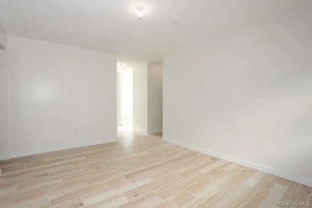 a view of an empty room and wooden floor