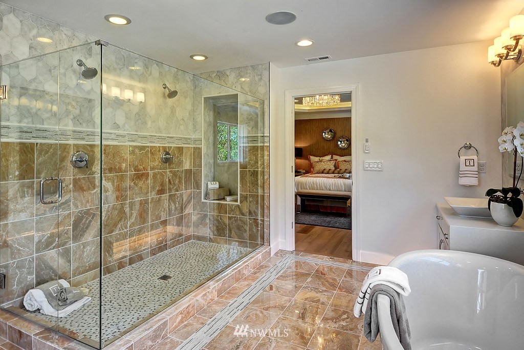 9911 Northeast 158th Street Bothell, WA 98011 - Photo 15 of 25 a bathroom with a granite countertop tub shower and mirror