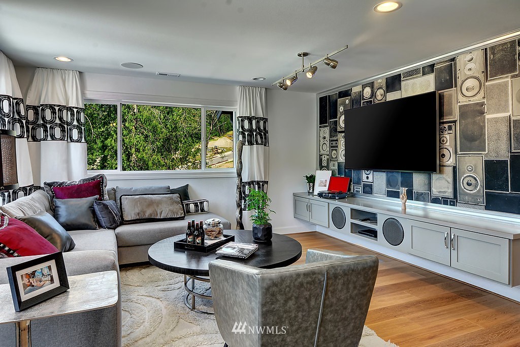 9911 Northeast 158th Street Bothell, WA 98011 - Photo 20 of 25 a living room with furniture a flat screen tv and a large window