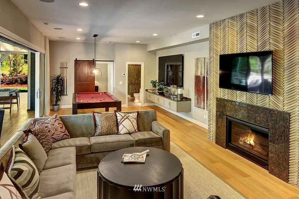 9911 Northeast 158th Street Bothell, WA 98011 - Photo 21 of 25 a living room with furniture a flat screen tv and a fireplace