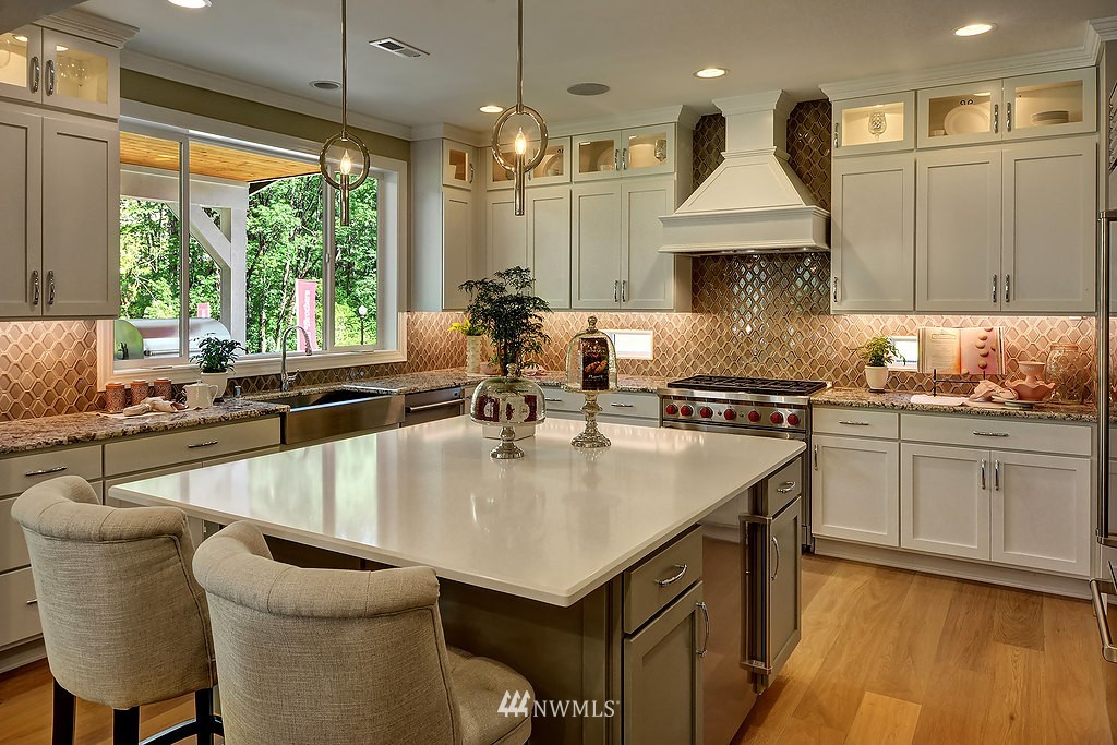 9911 Northeast 158th Street Bothell, WA 98011 - Photo 8 of 25 a kitchen with stainless steel appliances granite countertop a sink a stove and a wooden floors