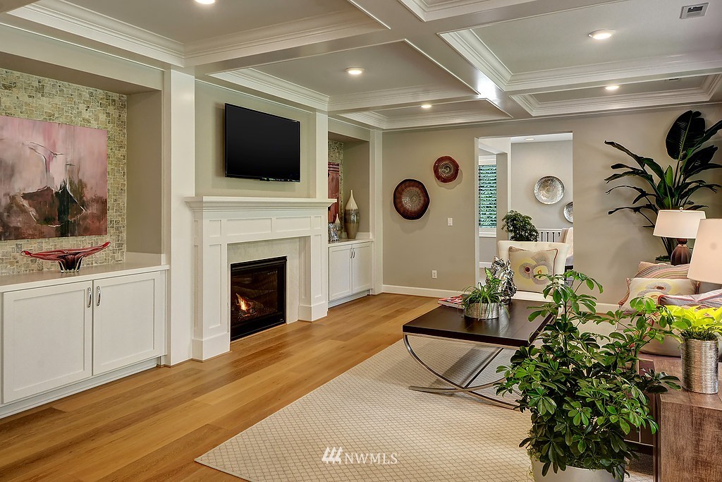 9911 Northeast 158th Street Bothell, WA 98011 - Photo 9 of 25 a living room with furniture a flat screen tv and a fireplace