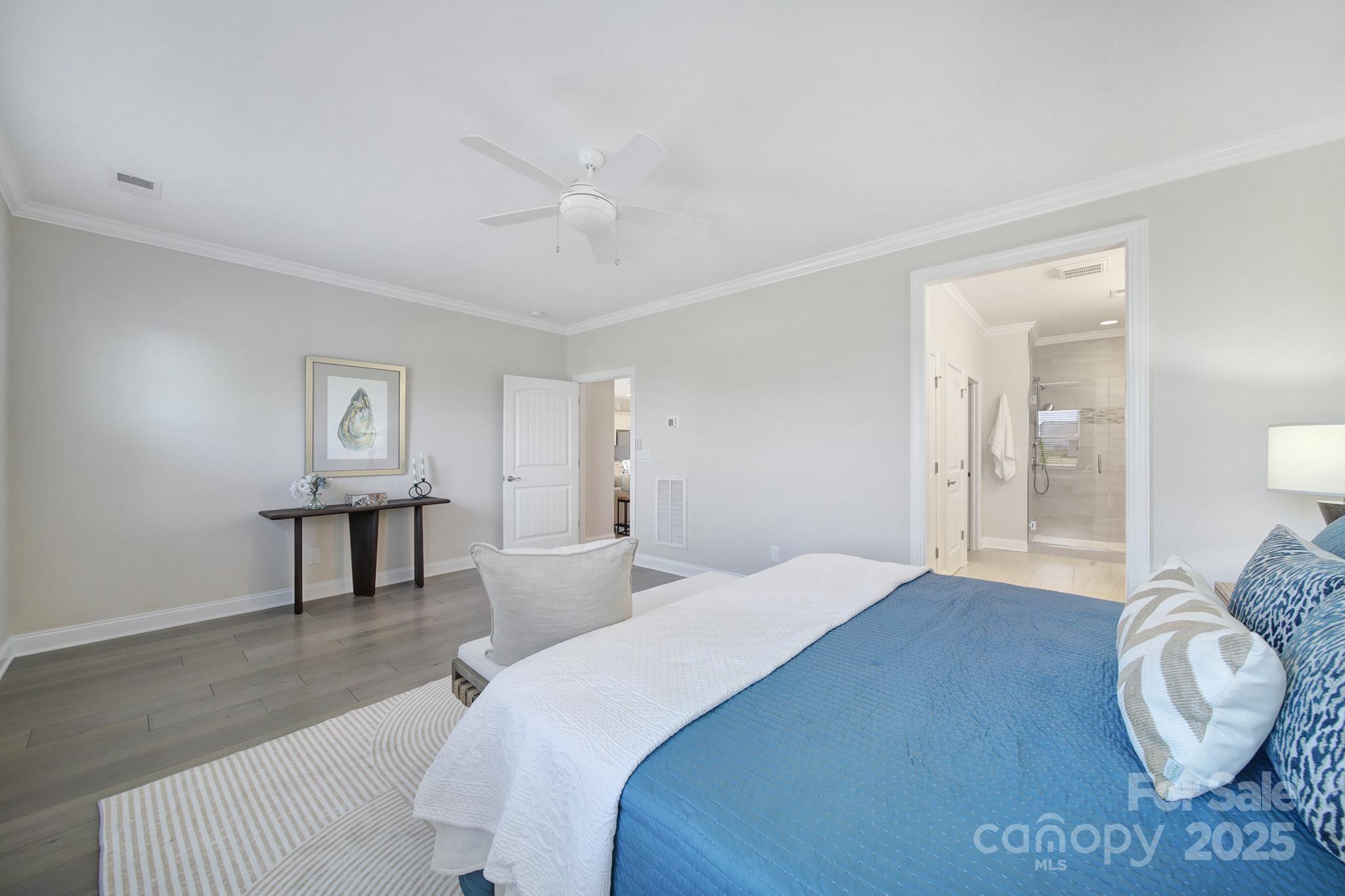 6255 Scuttle Lane, Unit 1104 Denver, NC 28037 - Photo 15 of 45 a bedroom with a bed and a chandelier