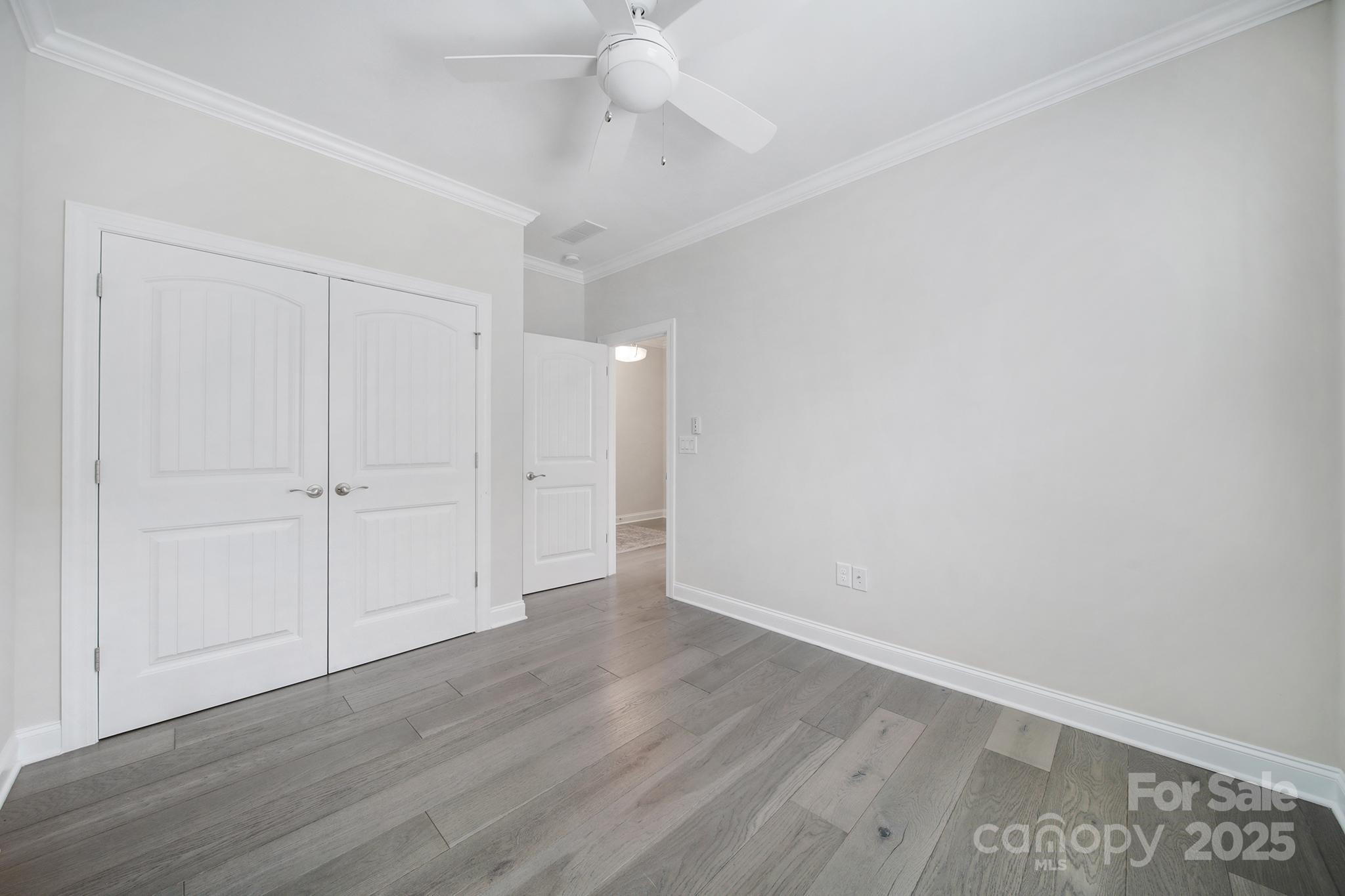 6255 Scuttle Lane, Unit 1104 Denver, NC 28037 - Photo 22 of 45 a view of an empty room with wooden floor