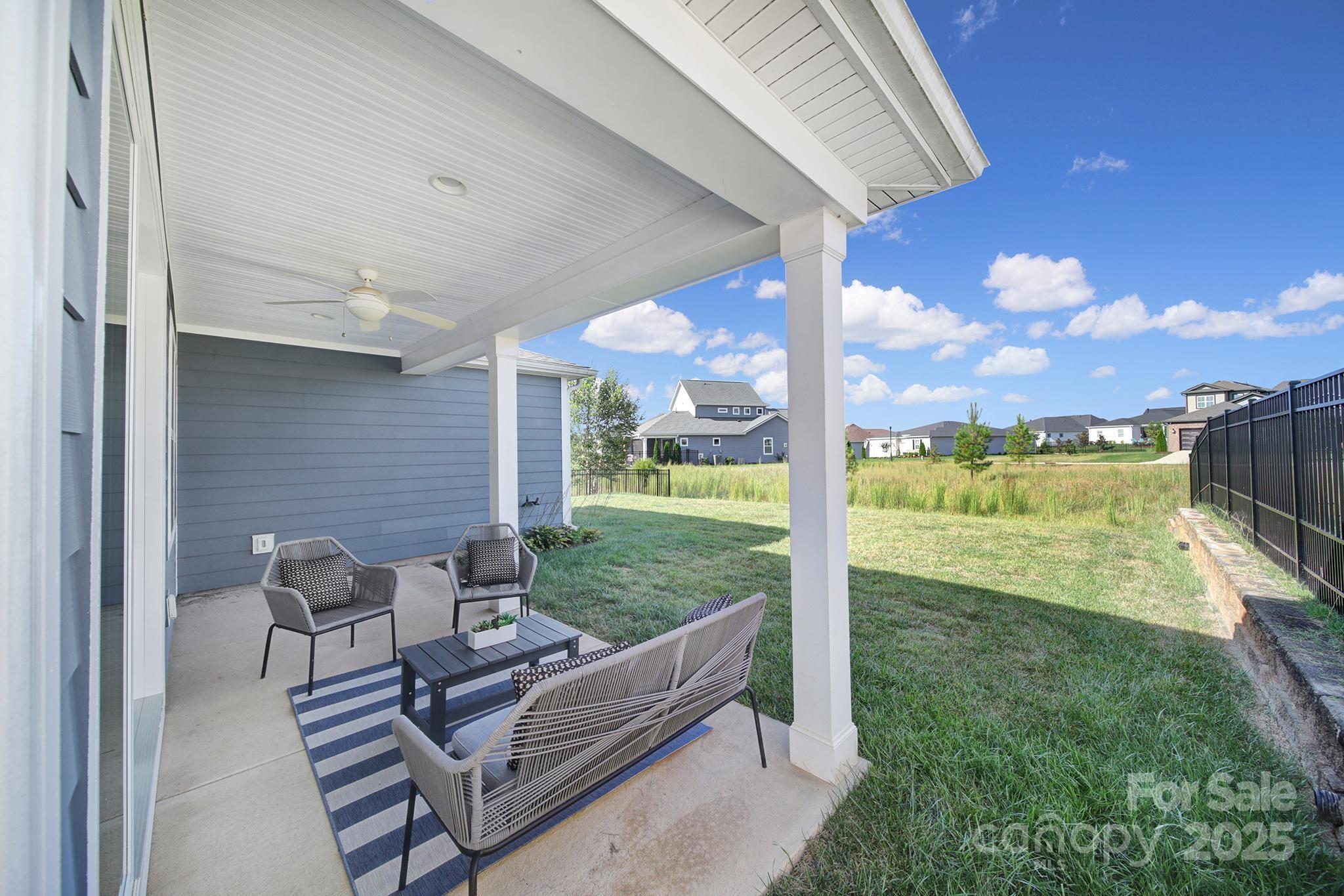 6255 Scuttle Lane, Unit 1104 Denver, NC 28037 - Photo 27 of 45 a view of a patio with a table chairs and a backyard