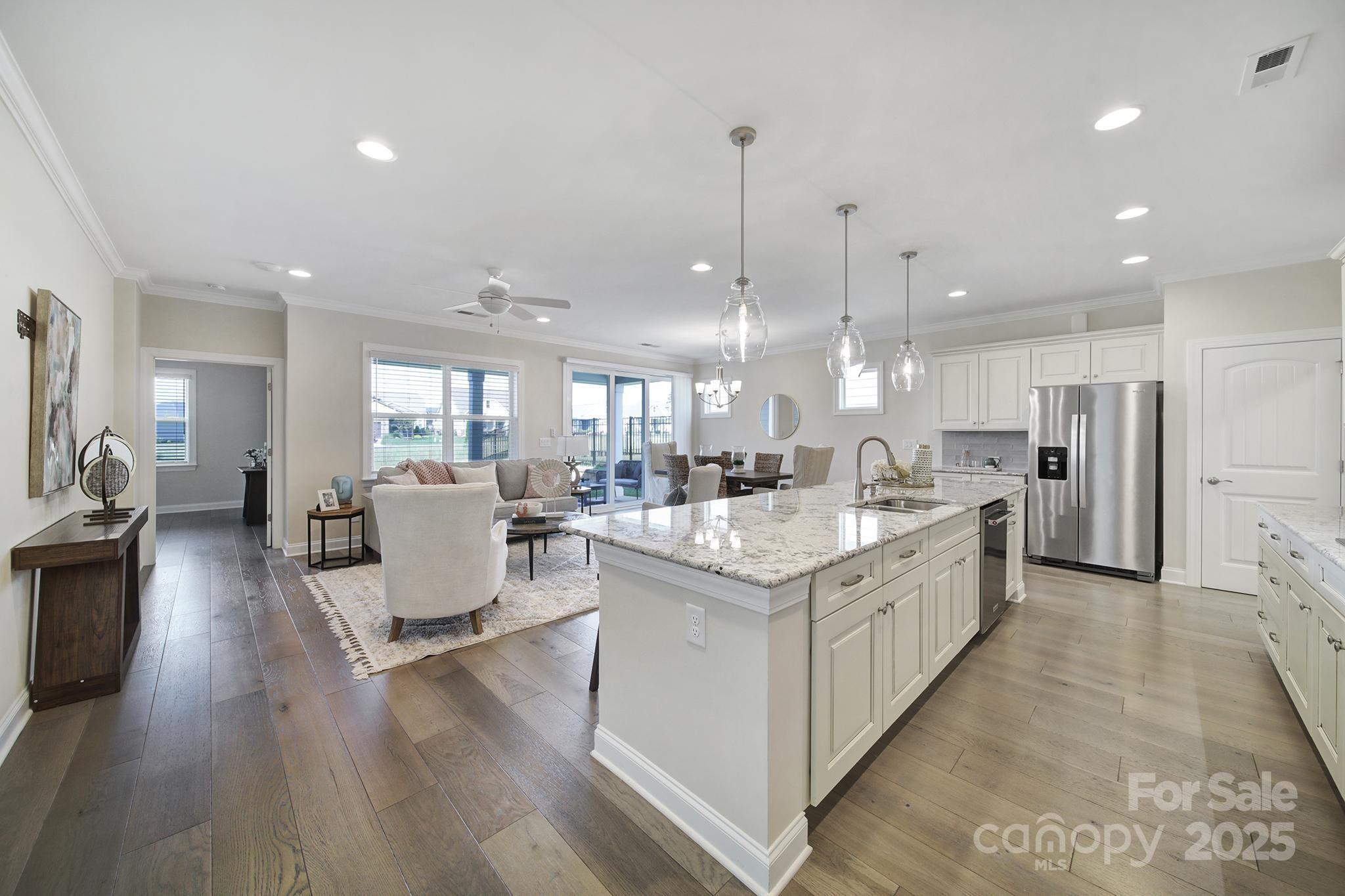 6255 Scuttle Lane, Unit 1104 Denver, NC 28037 - Photo 3 of 45 a large kitchen with stainless steel appliances kitchen island granite countertop a large island in the center
