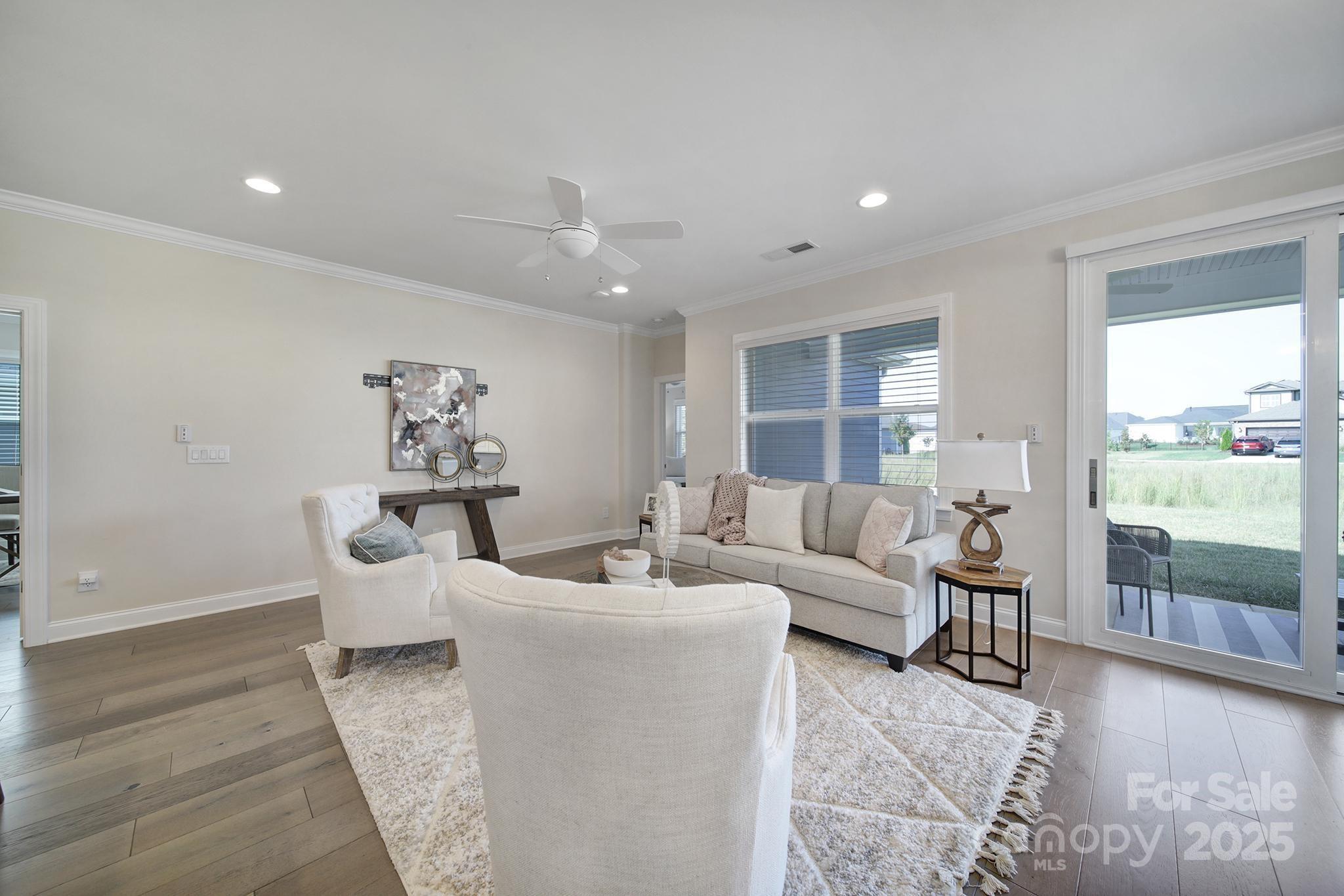 6255 Scuttle Lane, Unit 1104 Denver, NC 28037 - Photo 6 of 45 a living room with furniture and a large window