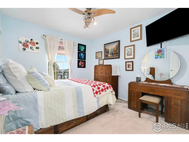 a bedroom with a bed and flat screen tv