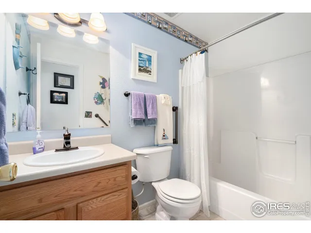 a bathroom with a sink vanity mirror and toilet