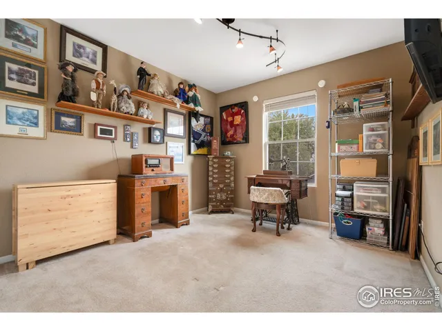 a living room with furniture cabinets and a window