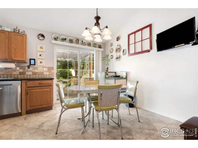 a view of a dining room with furniture and a chandelier