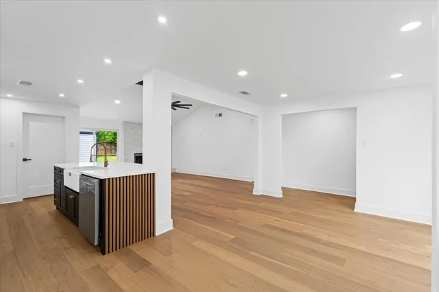 a view of kitchen with wooden floor and electronic appliances