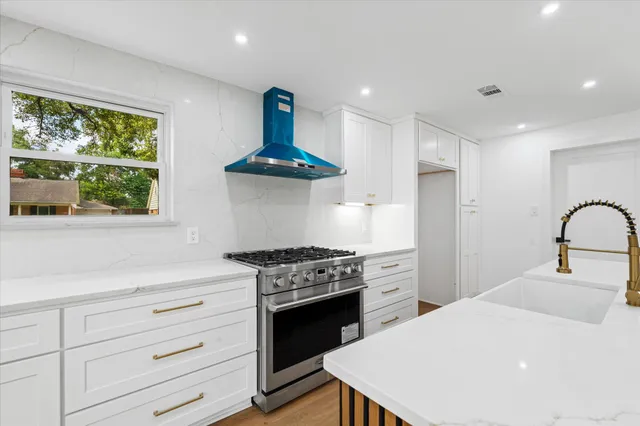 a kitchen with a stove a sink and a stove