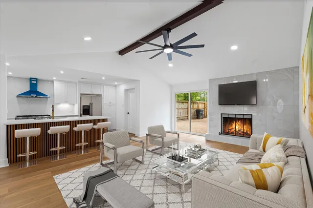 a living room with furniture a fireplace and a flat screen tv