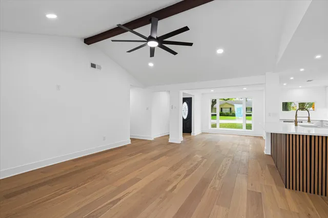wooden floor in an empty room with a window