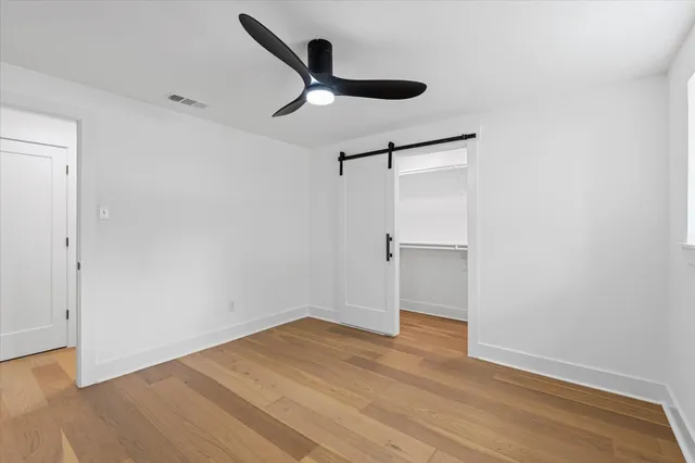 a view of empty room with wooden floor