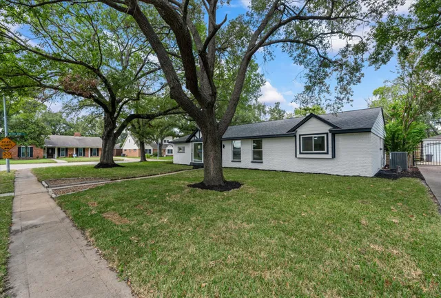a house with huge green field in front of it