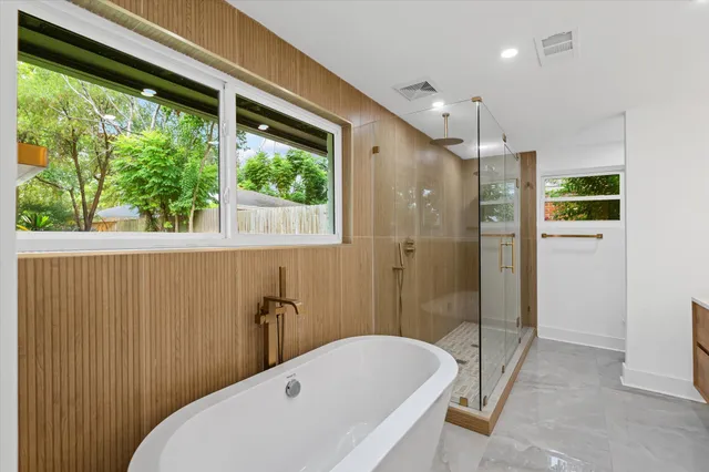 a bathroom with a tub and shower