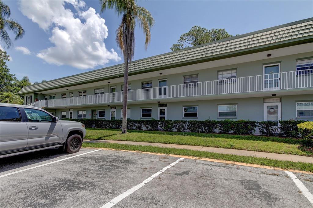 1433 South Belcher Road, Unit F13 Clearwater, FL 33764 - Photo 1 of 1 a view of a cars park in front of a building