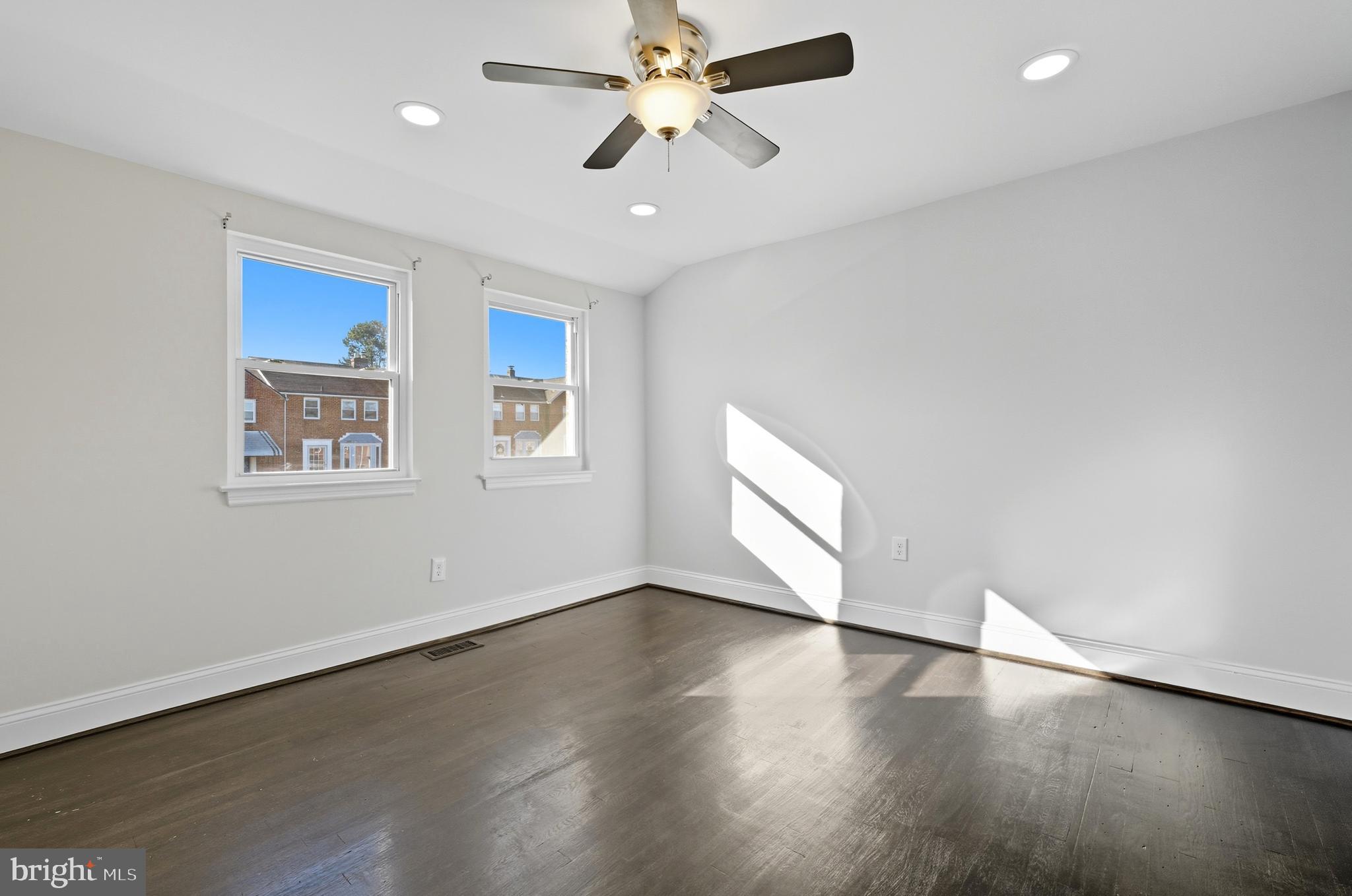 5768 Maplehill Road Baltimore, MD 21239 - Photo 15 of 29 a view of an empty room with window and wooden floor