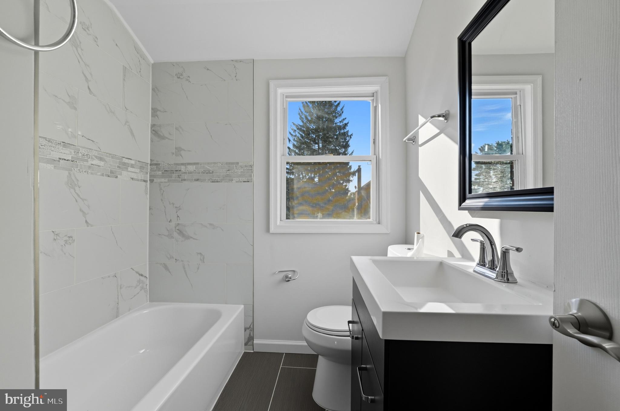 5768 Maplehill Road Baltimore, MD 21239 - Photo 16 of 29 a bathroom with a sink and a mirror