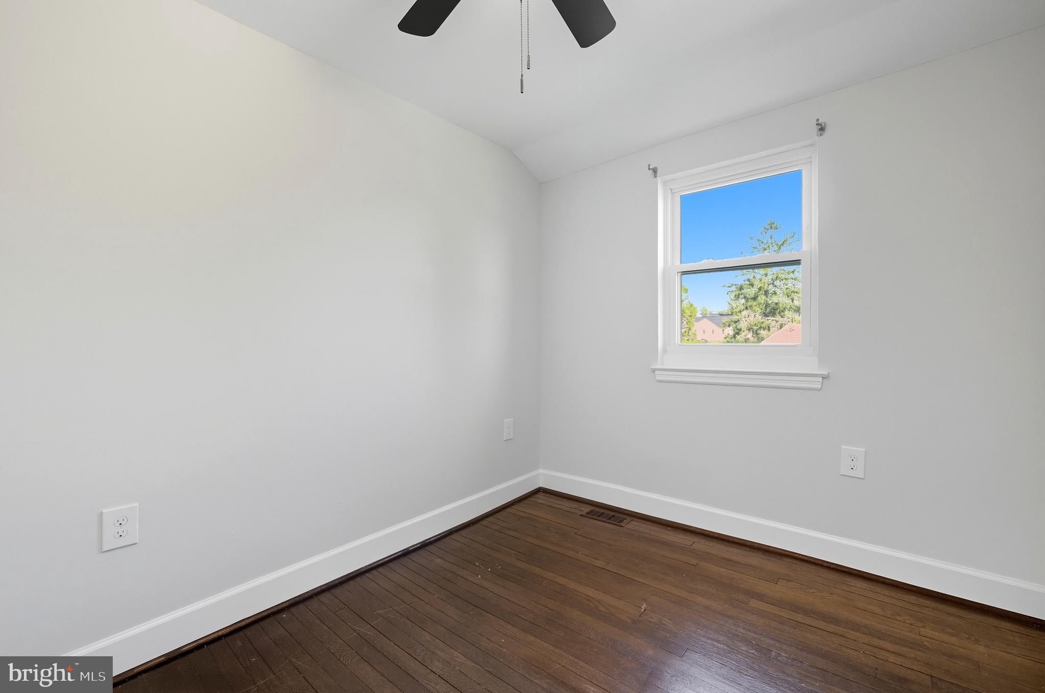 5768 Maplehill Road Baltimore, MD 21239 - Photo 19 of 29 wooden floor in an empty room with a window