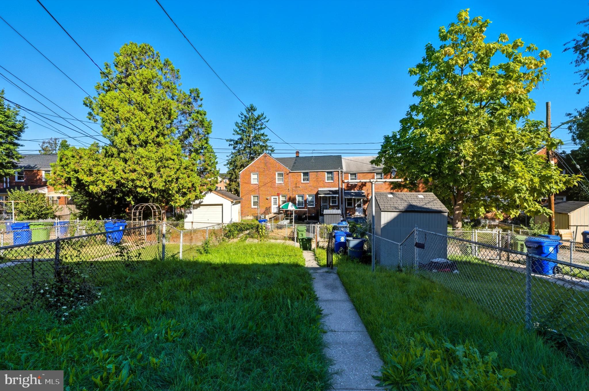 5768 Maplehill Road Baltimore, MD 21239 - Photo 22 of 29 a view of a house with a big yard and potted plants
