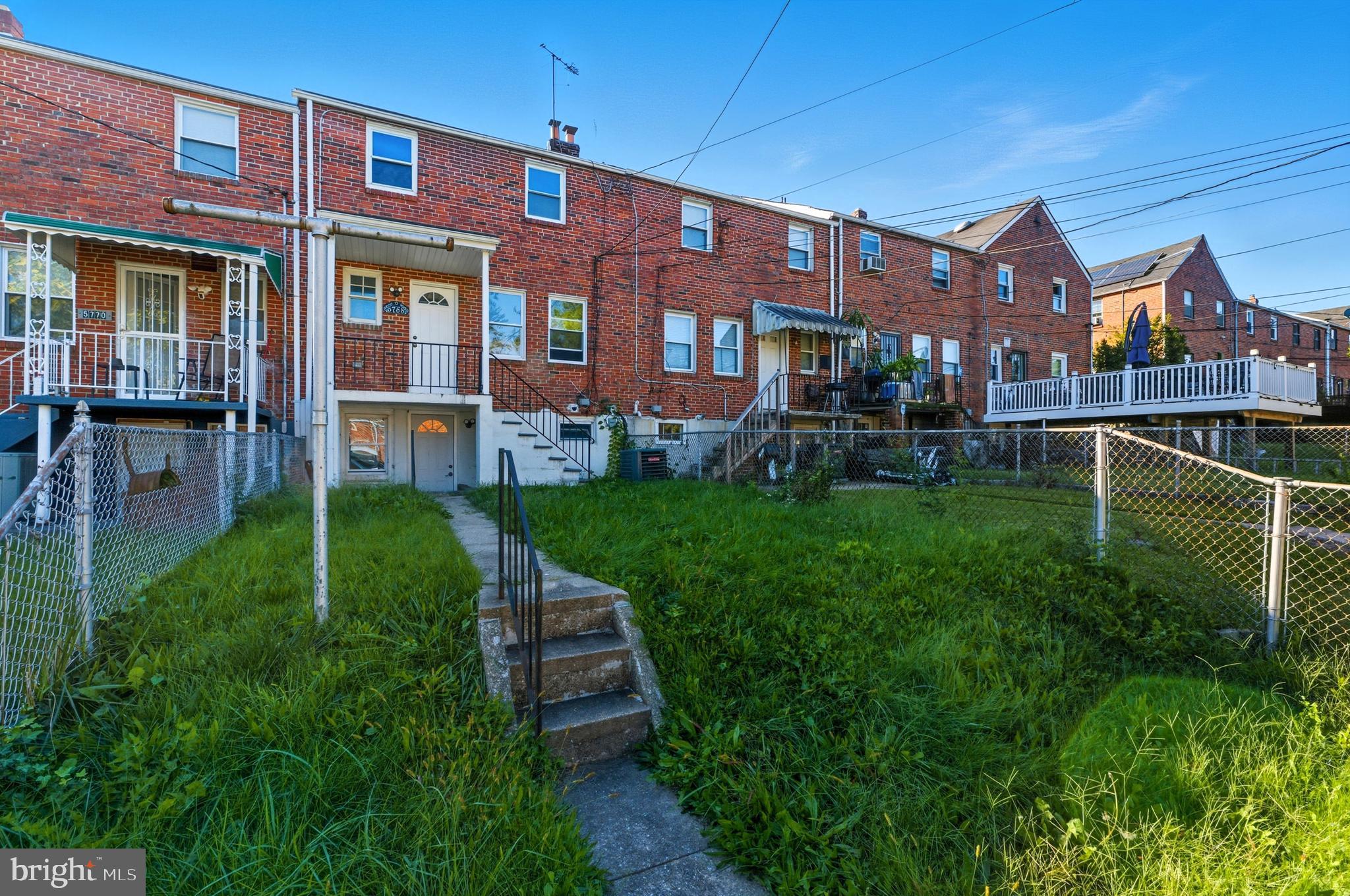 5768 Maplehill Road Baltimore, MD 21239 - Photo 23 of 29 a view of a brick building next to a yard