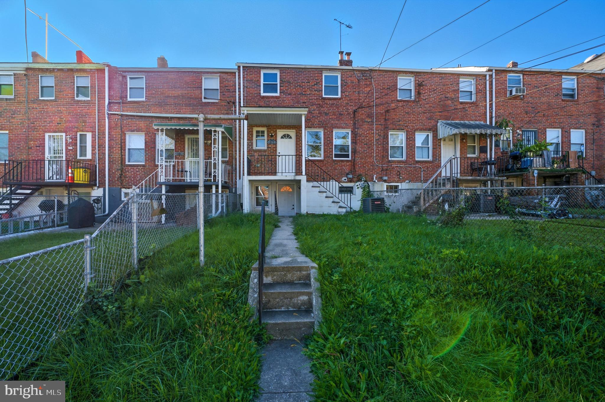 5768 Maplehill Road Baltimore, MD 21239 - Photo 24 of 29 a front view of a brick building with a yard
