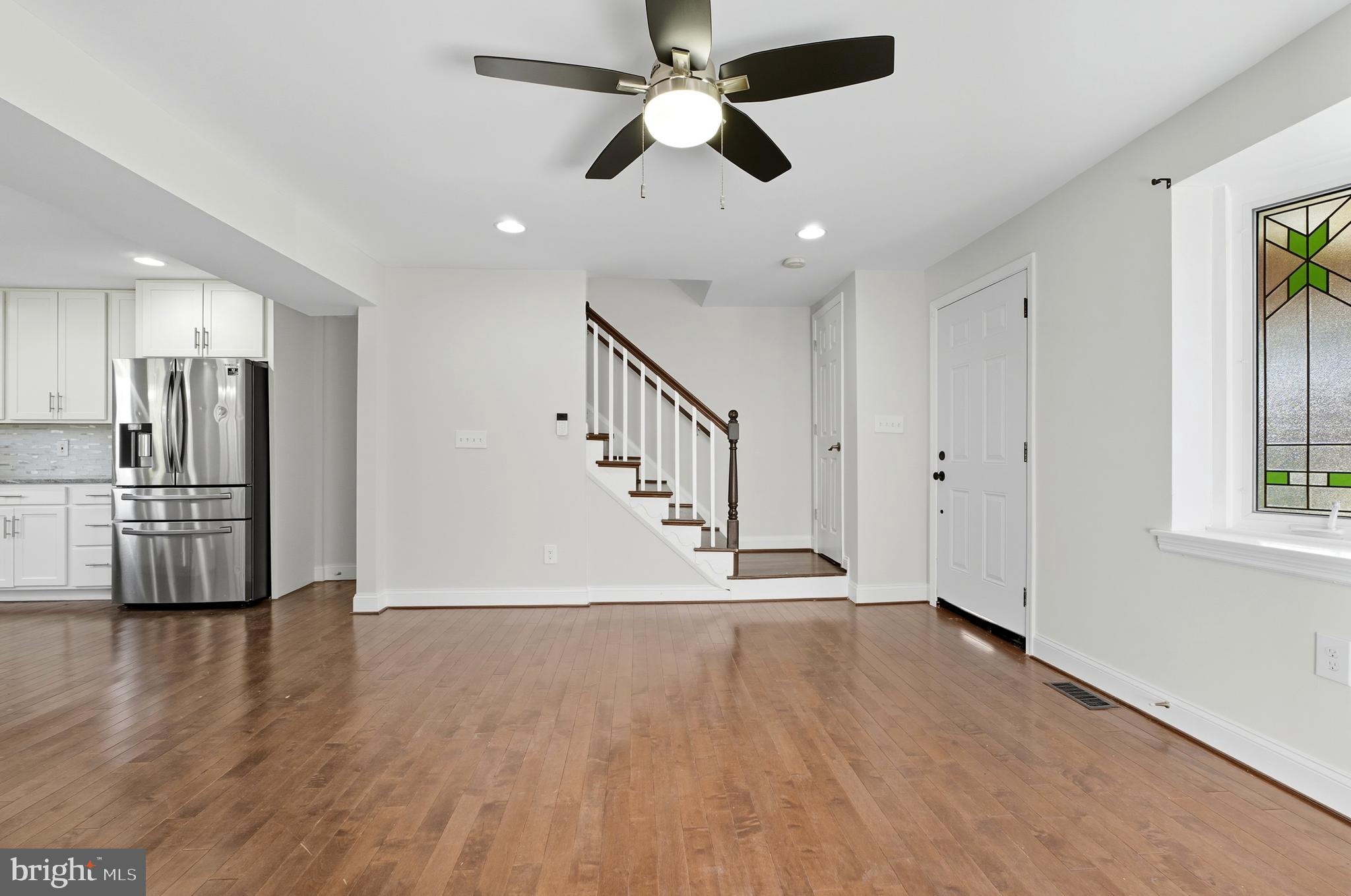 5768 Maplehill Road Baltimore, MD 21239 - Photo 3 of 29 a view of empty room with wooden floor and window