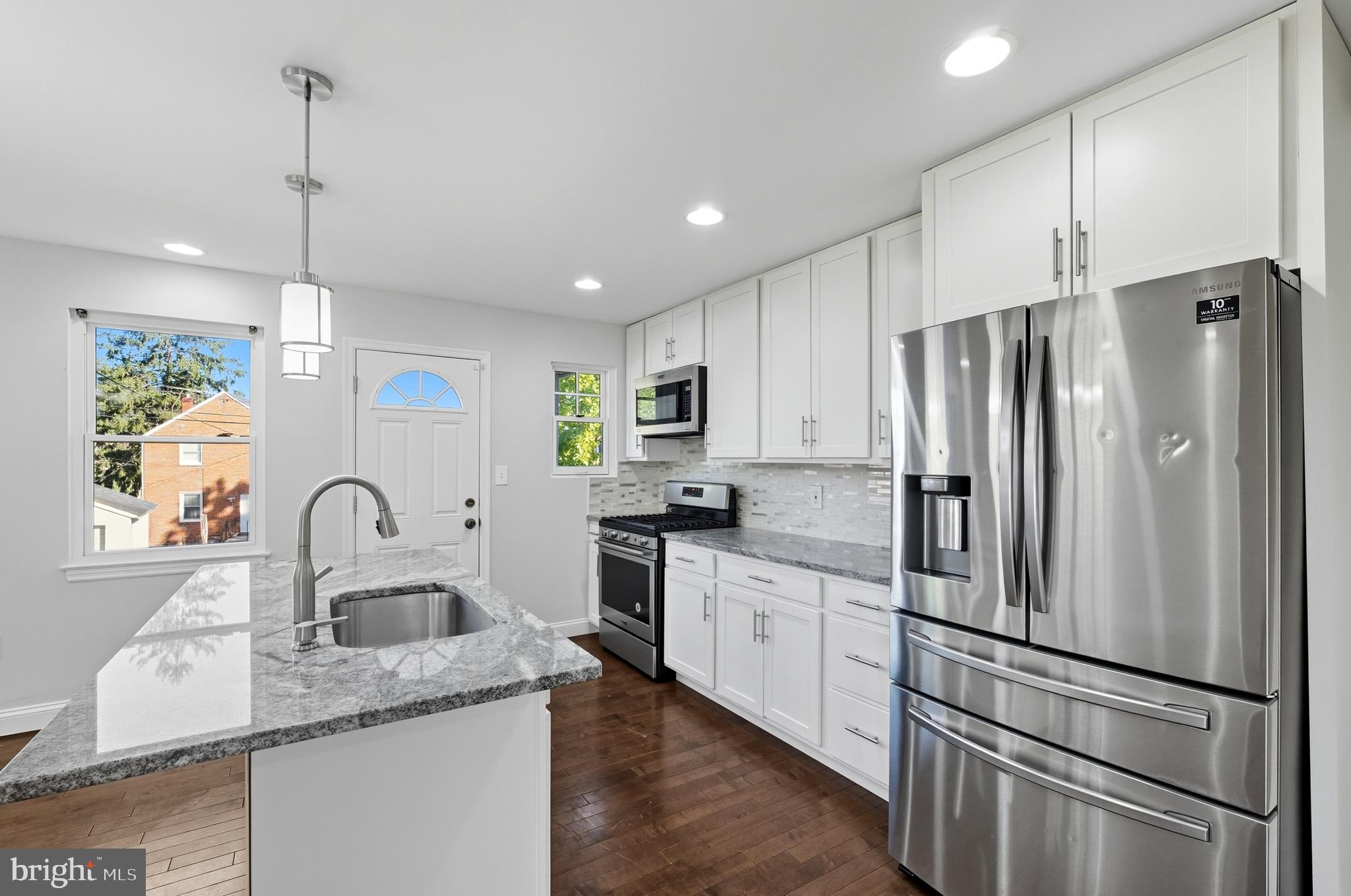 5768 Maplehill Road Baltimore, MD 21239 - Photo 4 of 29 a kitchen with kitchen island stainless steel appliances a refrigerator sink and microwave