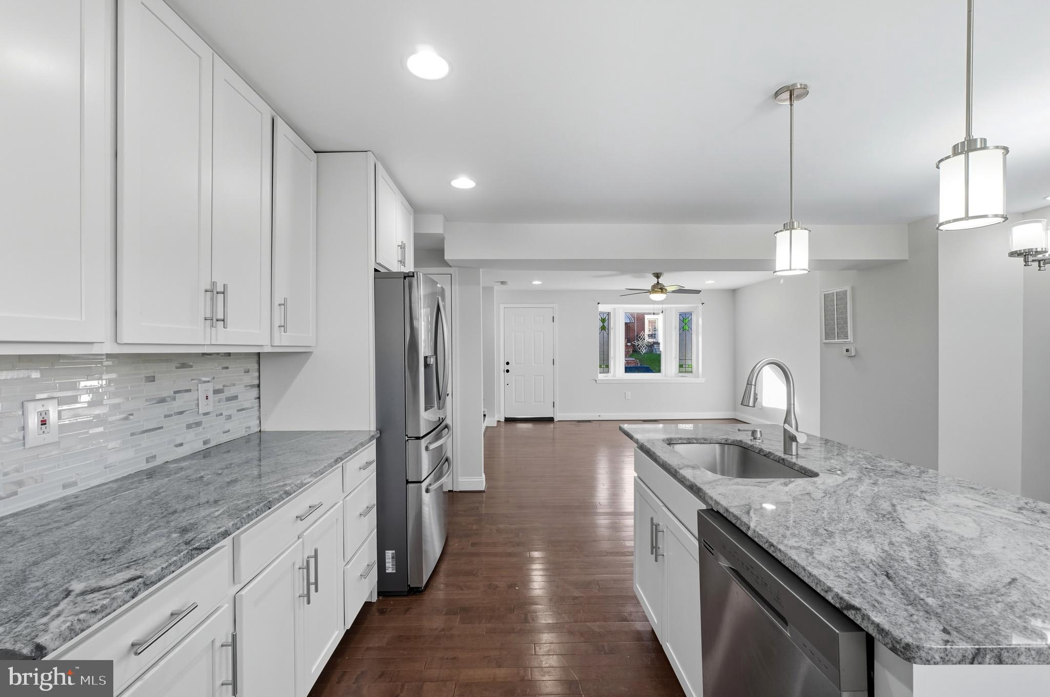 5768 Maplehill Road Baltimore, MD 21239 - Photo 6 of 29 a kitchen with stainless steel appliances granite countertop a sink refrigerator and cabinets