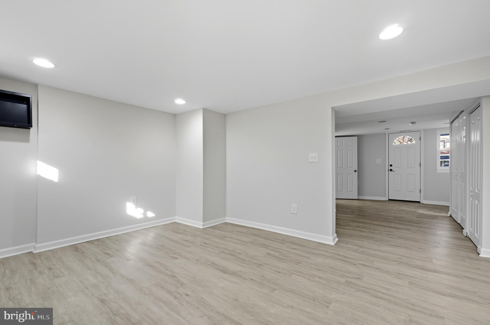 5768 Maplehill Road Baltimore, MD 21239 - Photo 10 of 29 wooden floor in an empty room with a window