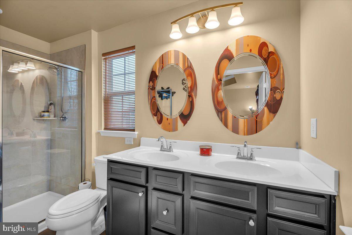 204 Freedom Way Sicklerville, NJ 08081 - Photo 15 of 32 a bathroom with a toilet a sink and a mirror