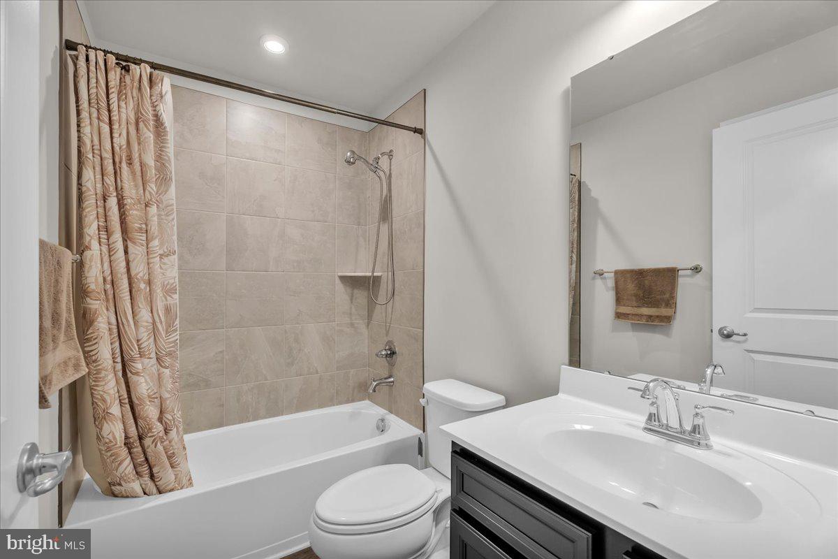 204 Freedom Way Sicklerville, NJ 08081 - Photo 17 of 32 a bathroom with a sink a toilet a mirror a bathtub and shower