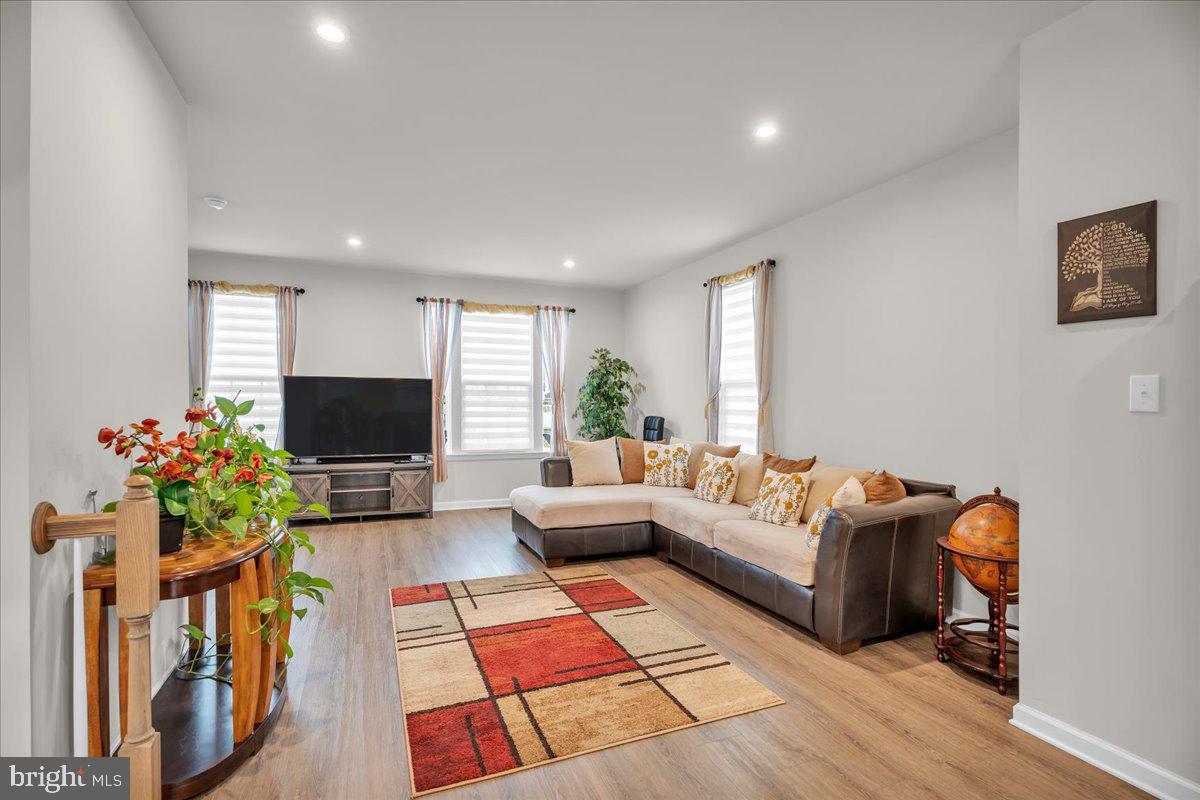 204 Freedom Way Sicklerville, NJ 08081 - Photo 6 of 32 a living room with furniture a flat screen tv and a potted plant