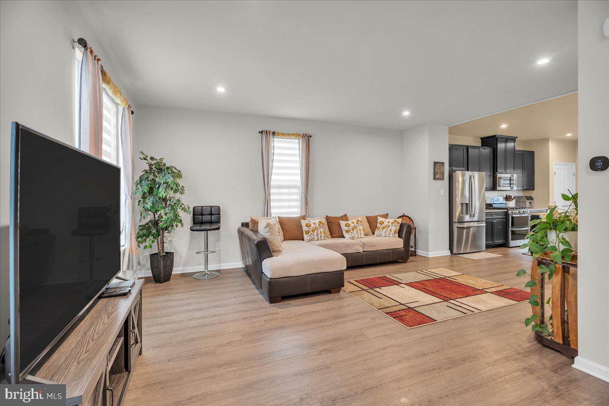 204 Freedom Way Sicklerville, NJ 08081 - Photo 7 of 32 a living room with furniture and a flat screen tv