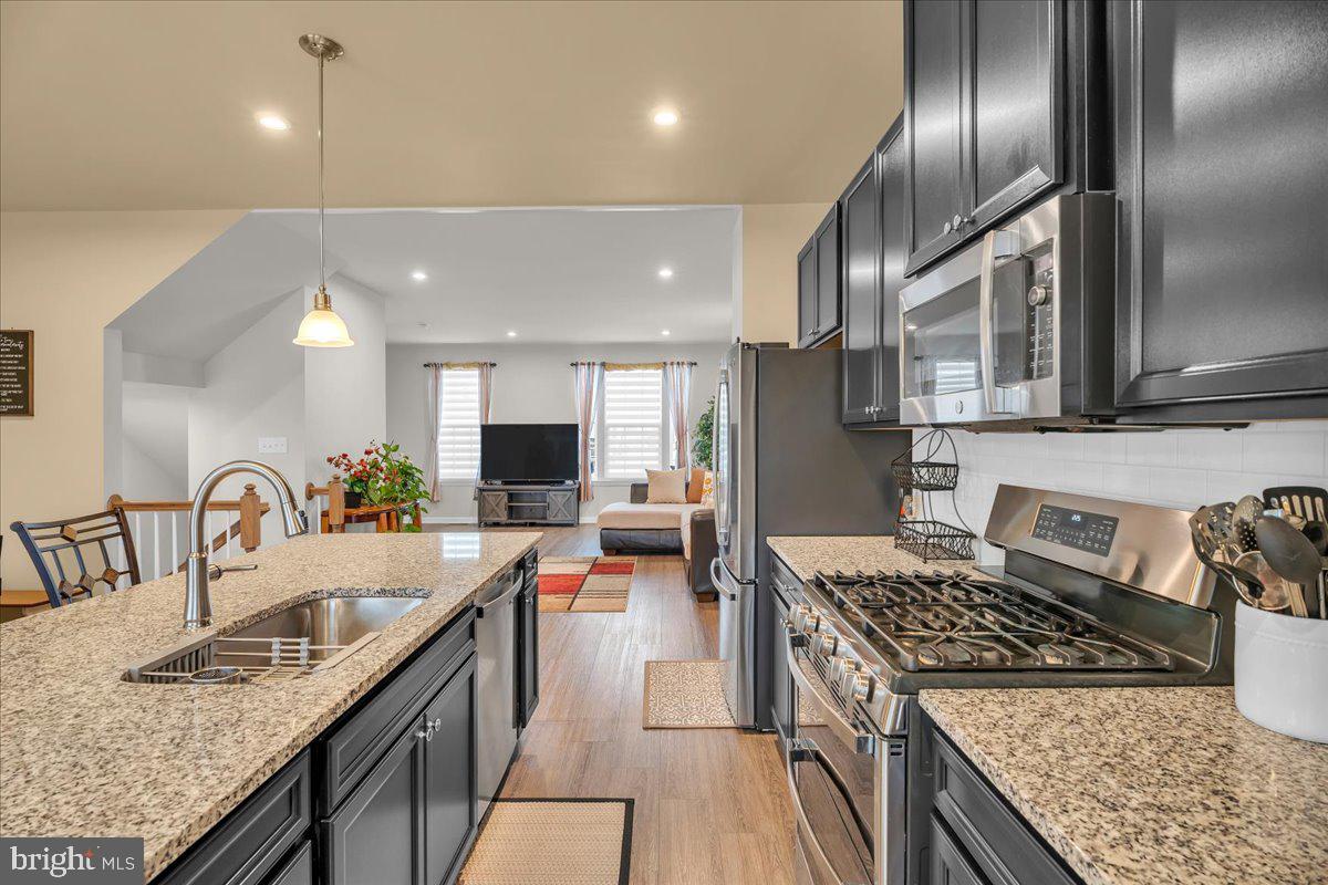 204 Freedom Way Sicklerville, NJ 08081 - Photo 10 of 32 a kitchen with stainless steel appliances granite countertop a sink stove and refrigerator
