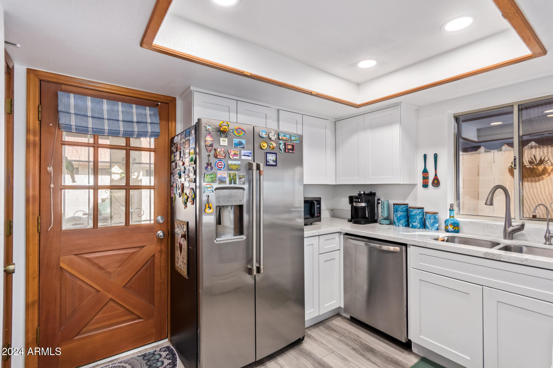 542 South Higley Road, Unit 73 Mesa, AZ 85206 - Photo 8 of 34 a kitchen with stainless steel appliances a refrigerator sink and cabinets