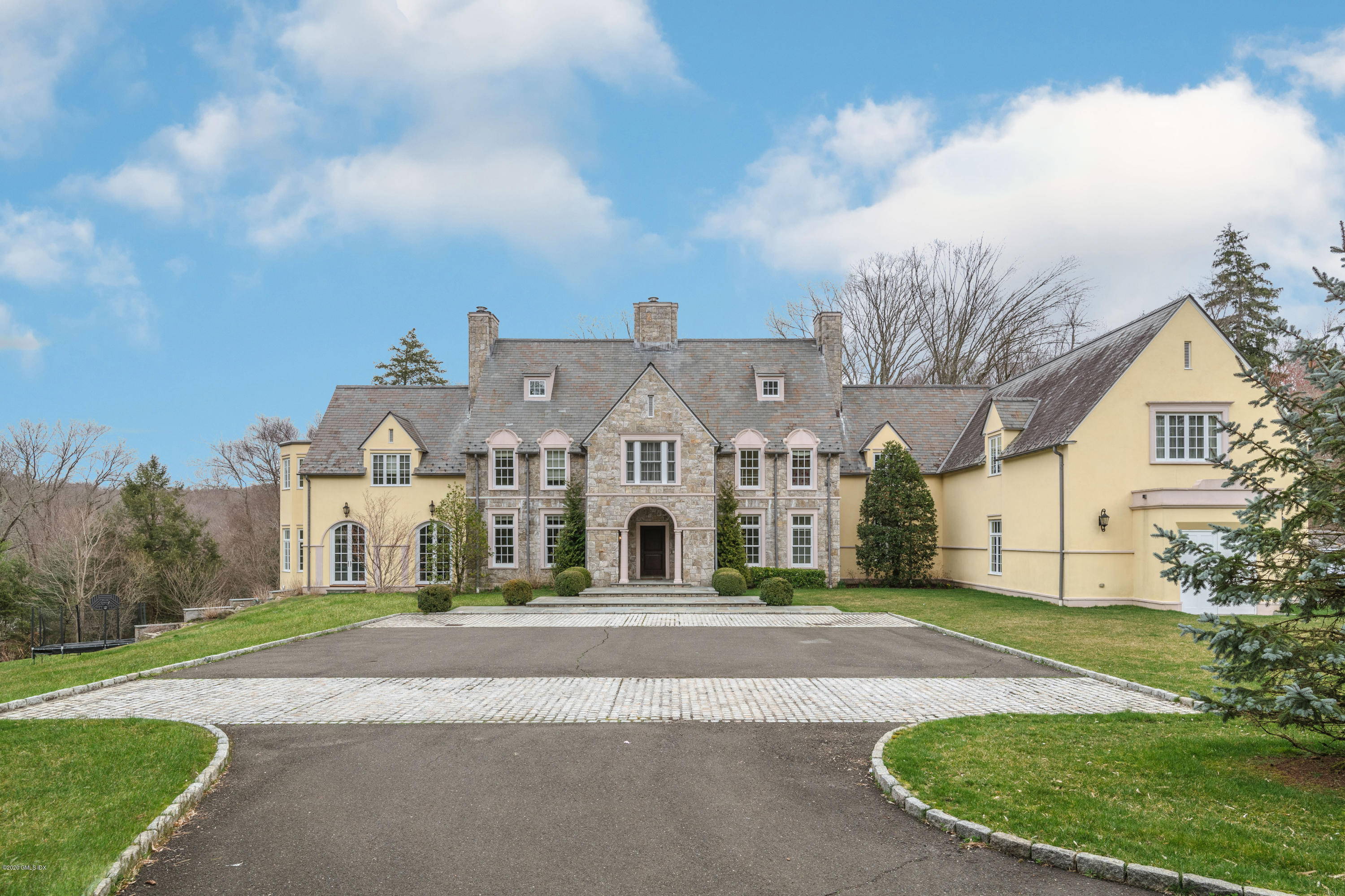 a front view of a house with a garden
