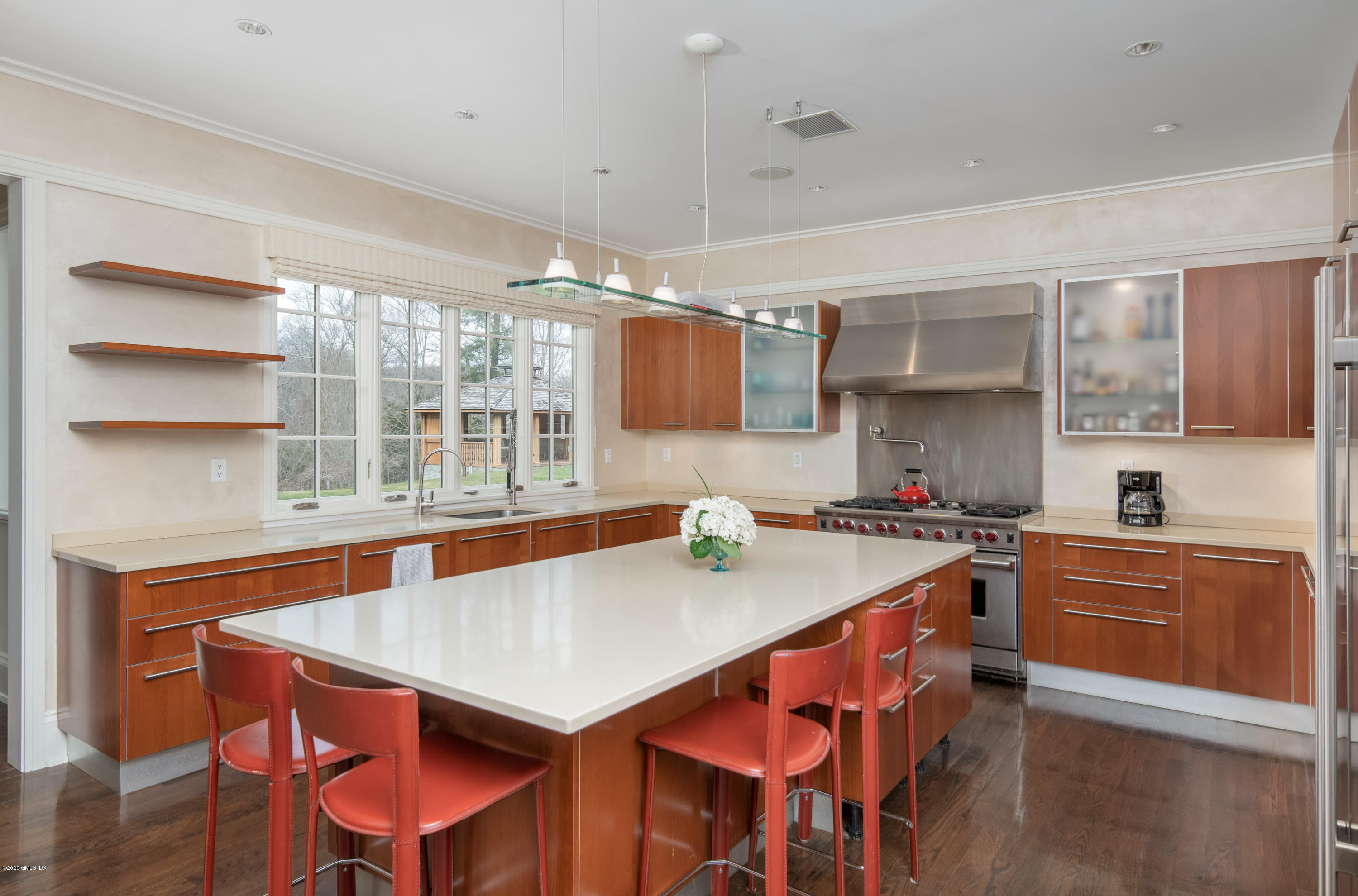 397 Riversville Road Greenwich, CT 06831 - Photo 7 of 21 a kitchen with a stove a table and chairs in it