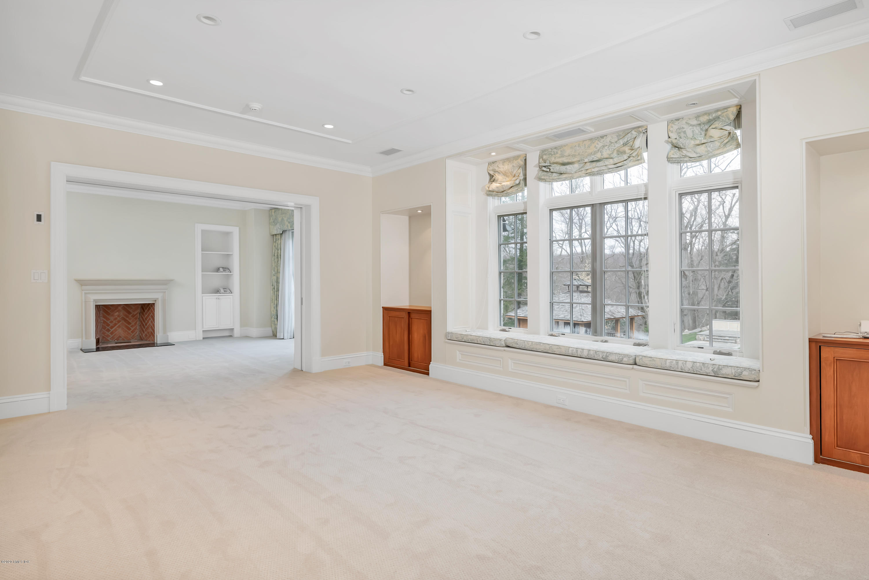 397 Riversville Road Greenwich, CT 06831 - Photo 9 of 21 a big room with windows and a chandelier
