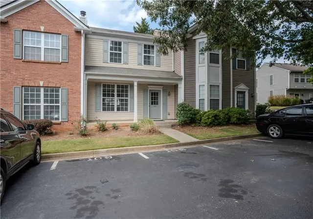 a view of a brick house with a large windows next to a road