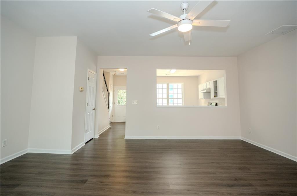 4645 Valais Court, Unit 109 Alpharetta, GA 30022 - Photo 12 of 27 a view of an empty room with wooden floor and a window